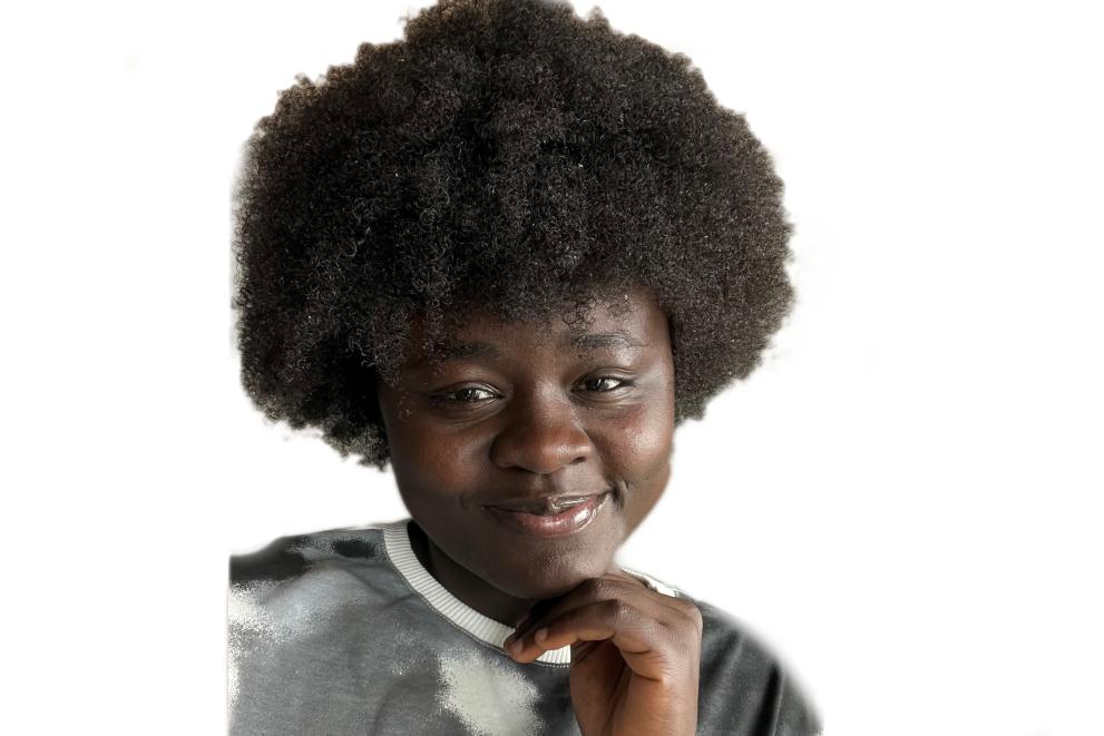 Close-up of a young Black woman with curly hair, gently smiling.